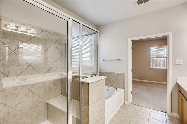 a spacious bathroom with a shower and a sink