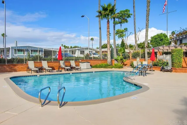 a view of swimming pool with a lounge chairs