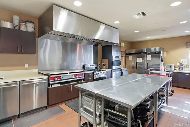a kitchen with a stove a refrigerator and a sink
