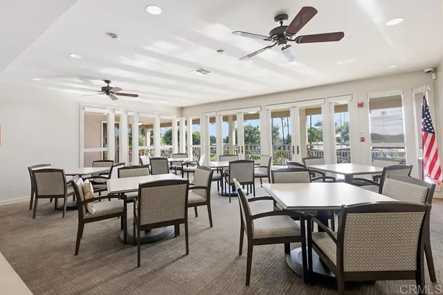 a dining room with furniture a rug and a chandelier