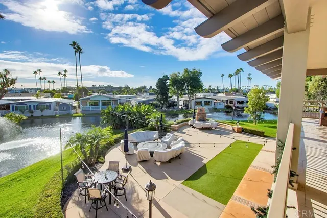 a view of a patio with couches chairs and a yard