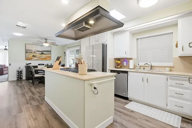 a kitchen with cabinets and wooden floor