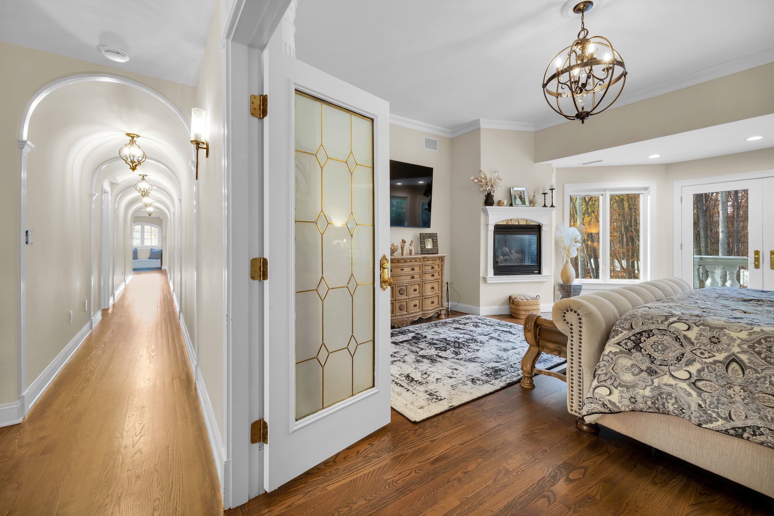 65 Ironwood Road Guilford, CT 06437 - Photo 18 of 40 a spacious bedroom with a bed and a chandelier
