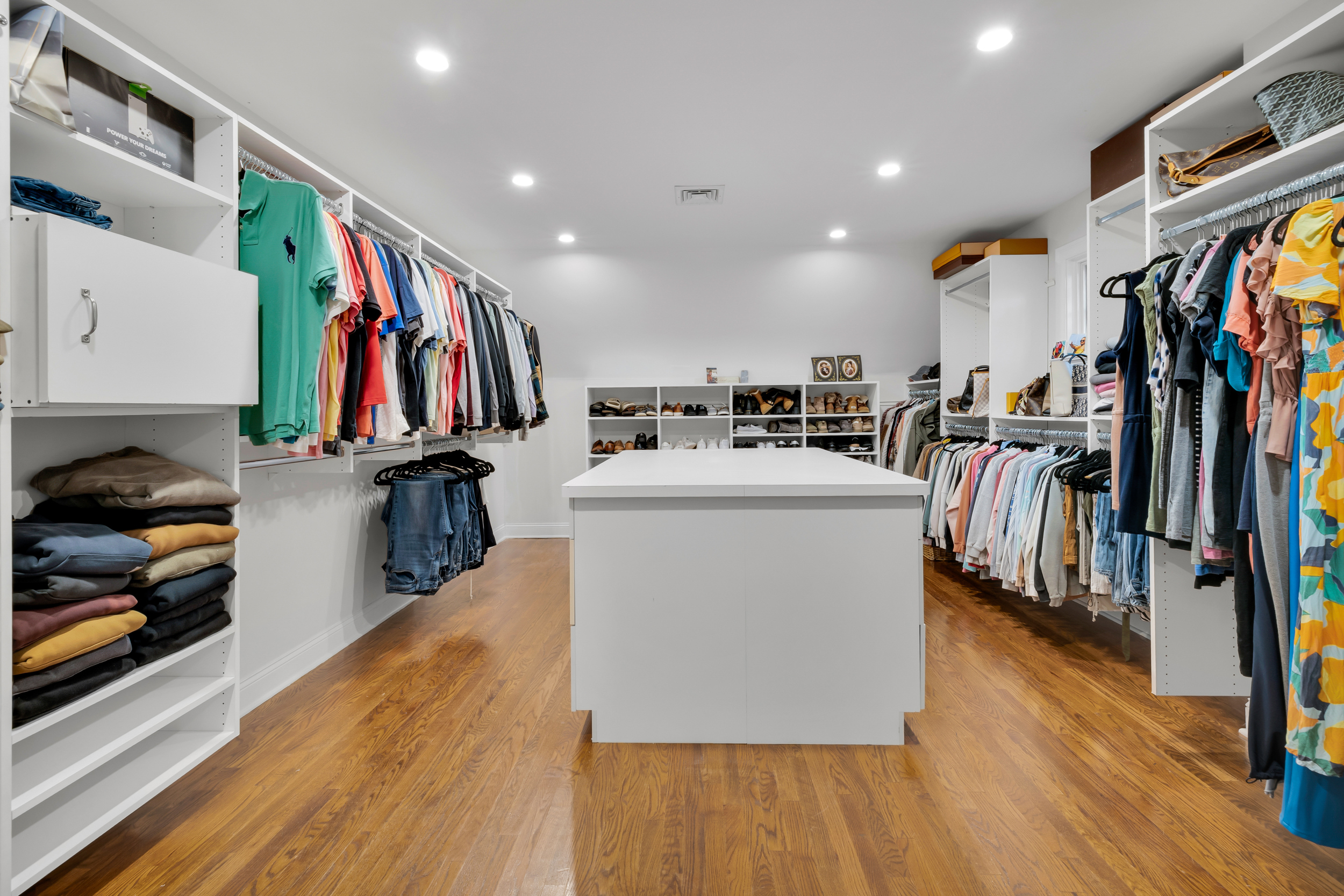 65 Ironwood Road Guilford, CT 06437 - Photo 22 of 40 a view of walk in closet with clothes shoes and a view of living room