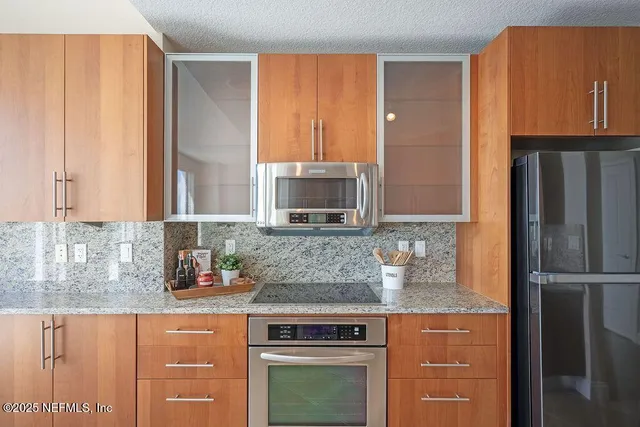 a living room with furniture and a gym area