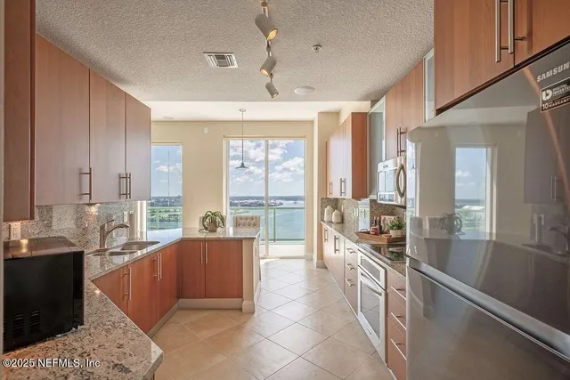 a view of a hallway with stairs and wooden floor