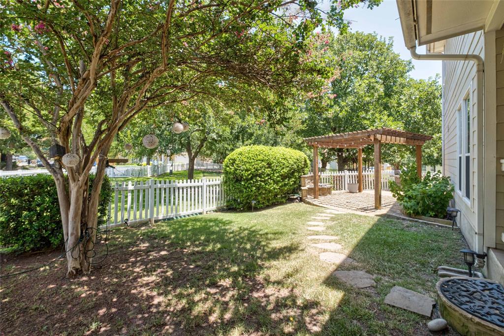 2730 Kinney Oaks Court Austin, TX 78704 - Photo 26 of 32 Mature trees shade a peaceful backyard lawn complete with a classic white picket fence.