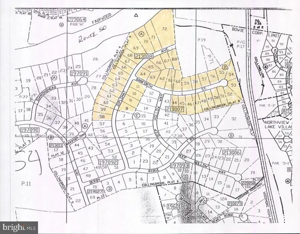 view of a white bed and a wooden floor