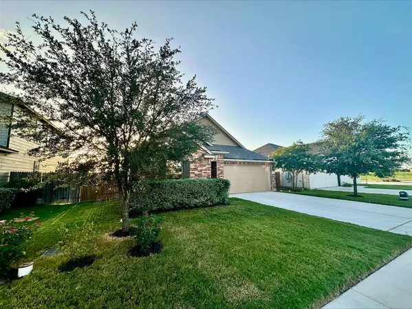 a view of a house with a yard and tree s