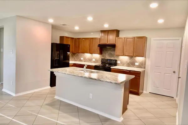 a kitchen with stainless steel appliances granite countertop a sink counter space and cabinets