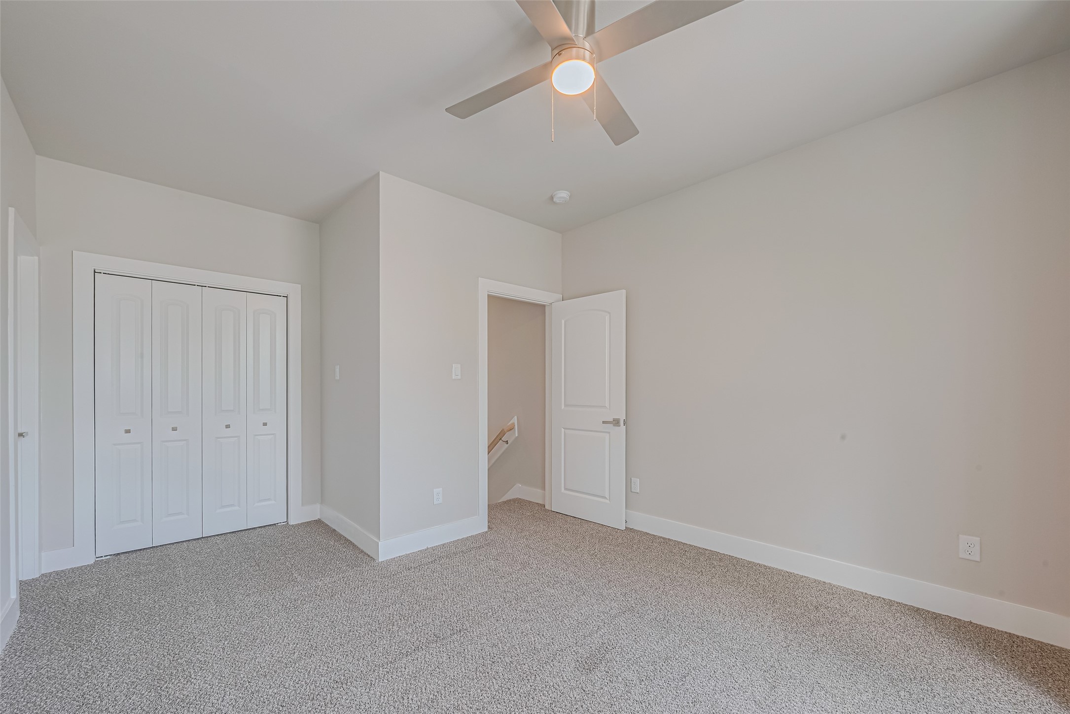 7207 Force Street Houston, TX 77020 - Photo 21 of 29 This room features neutral walls, carpeted flooring, a ceiling fan, and a spacious closet with double doors.