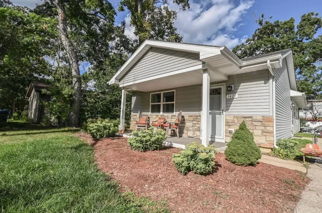 a front view of a house with garden