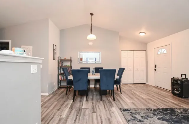 a view of a dining room with furniture and wooden floor