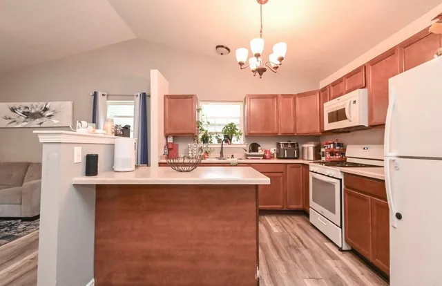 a kitchen with stainless steel appliances a sink stove and refrigerator