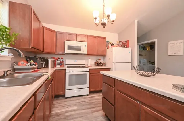 a kitchen with a sink stove and refrigerator