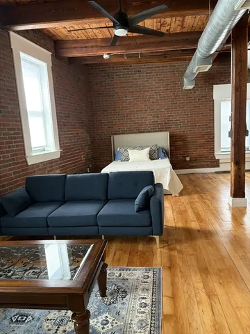 a living room with furniture and a rug