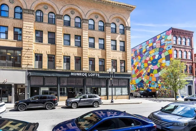 a couple of cars parked in front of a building