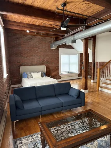a living room with a couch and a rug