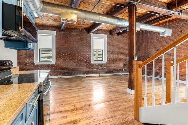 a view of a living room and kitchen with a large window