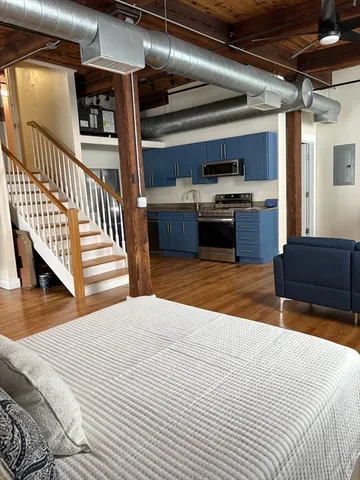 a kitchen with stainless steel appliances kitchen island granite countertop a sink and cabinets