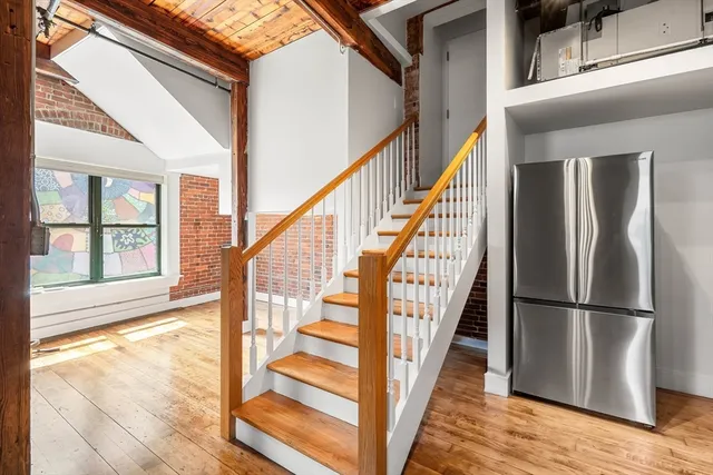 a view of an entryway with wooden floor and door
