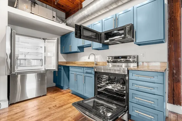 a kitchen with stainless steel appliances granite countertop a stove and a sink