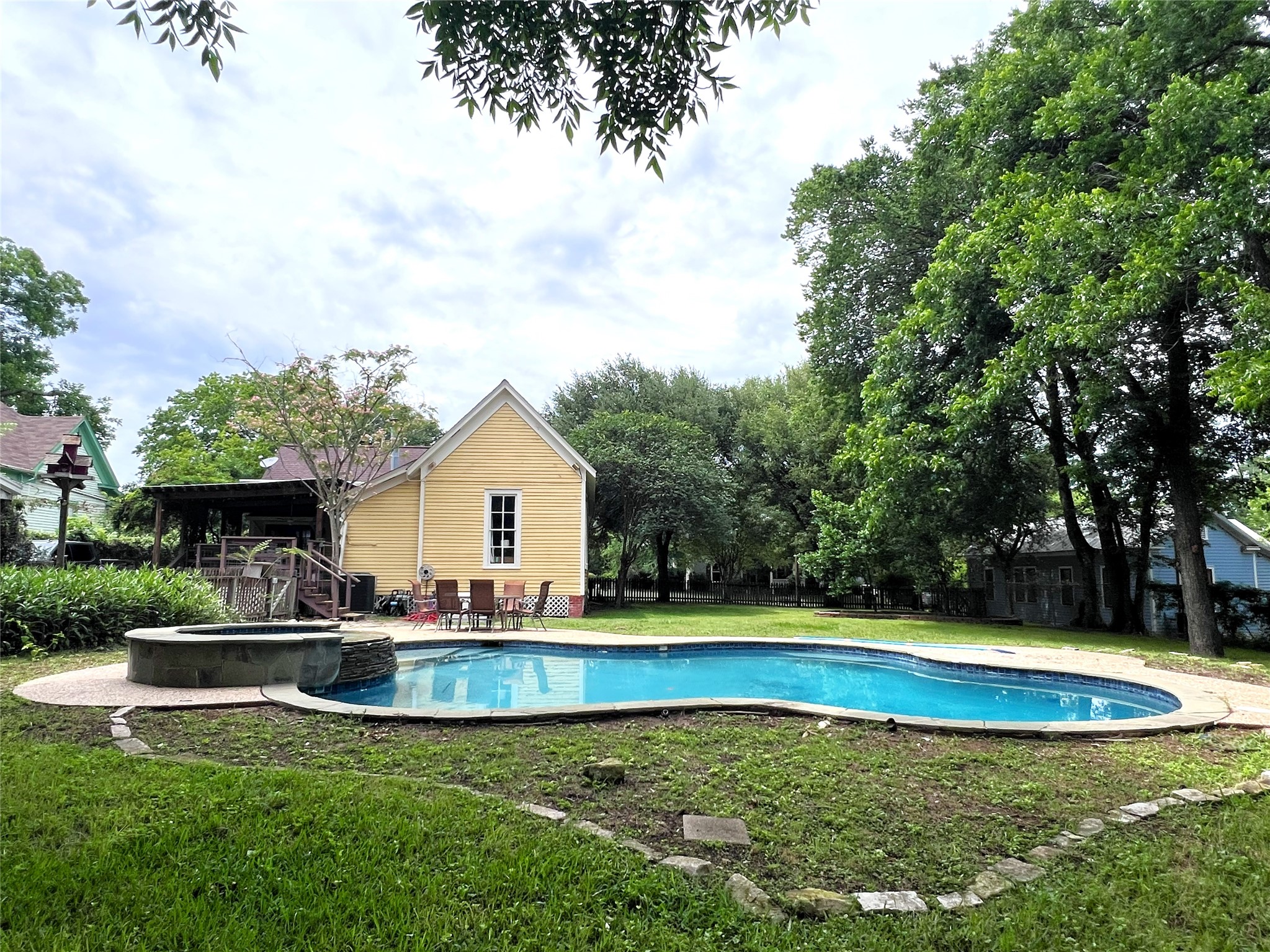 606 Sycamore Street Brenham, TX 77833 - Photo 2 of 27 a view of a house with swimming pool and a yard