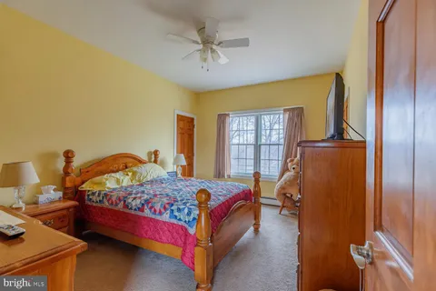 a spacious bathroom with a granite countertop sink and a mirror