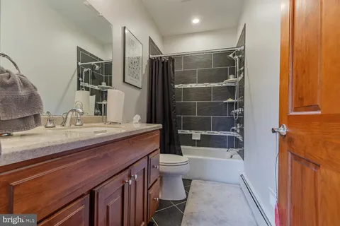 a bedroom with bed and wooden floor