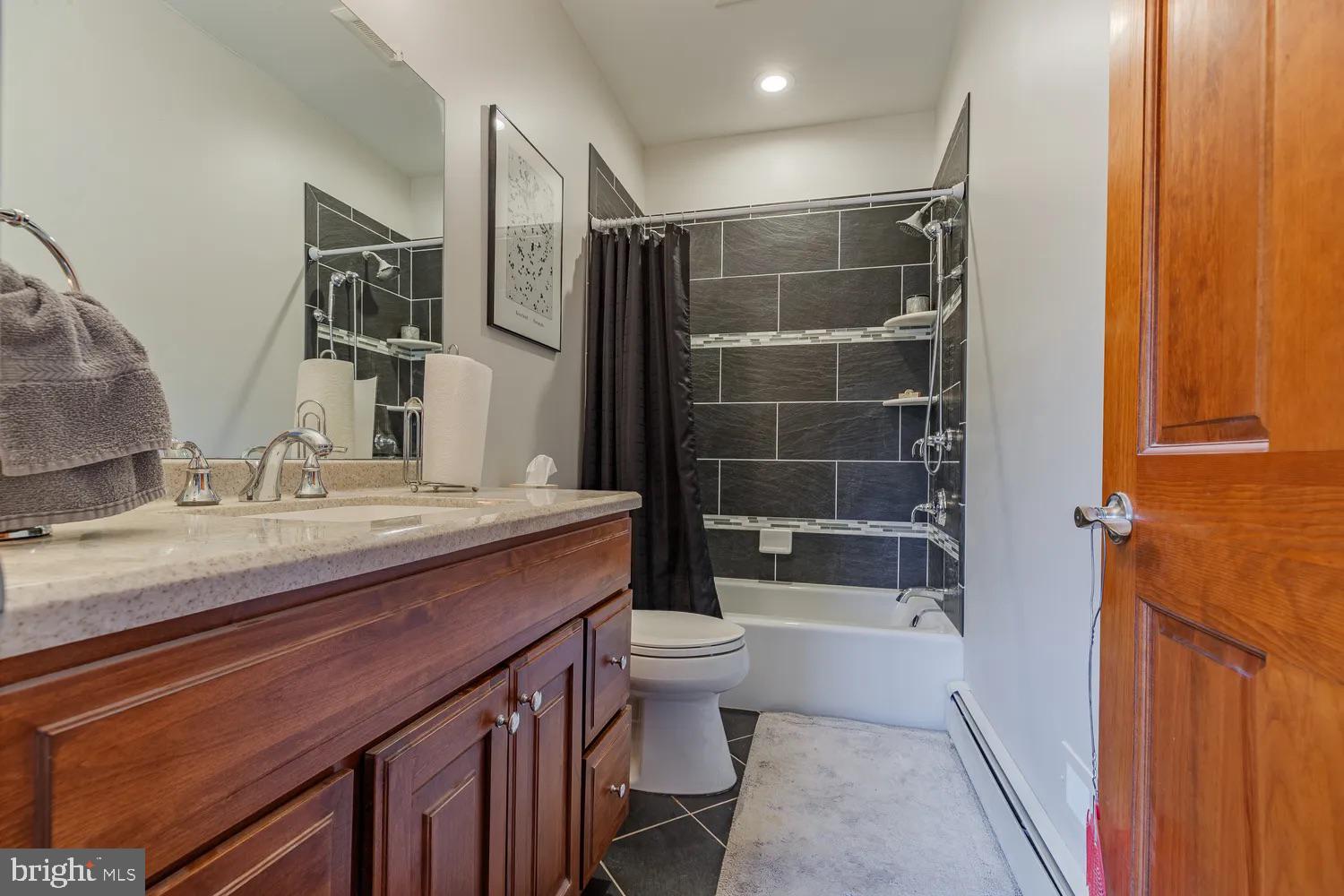 33487 Galena Sassafras Road Galena, MD 21635 - Photo 23 of 59 a bathroom with a granite countertop sink a toilet and shower