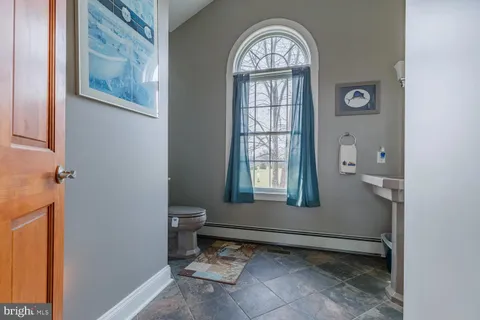 a bed room with a bed window and a flat screen tv