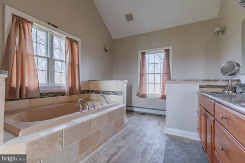 a view of a house with a yard and a garden