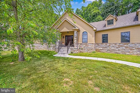 a house view with swimming pool in front of the house