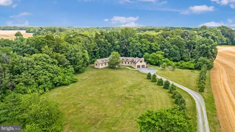 view of a house with a yard and trees