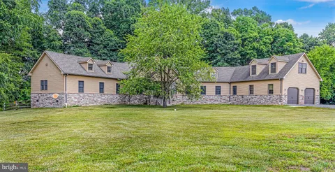 a kitchen with stainless steel appliances granite countertop a refrigerator a stove and a sink with cabinets