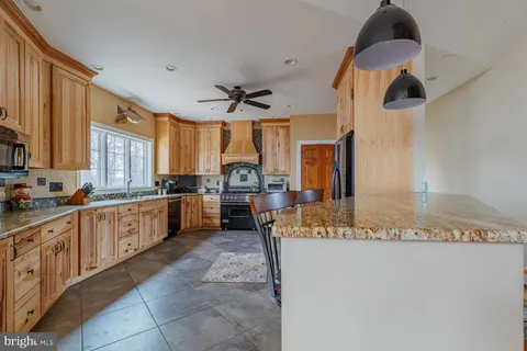 a kitchen with a sink appliances cabinets and furniture