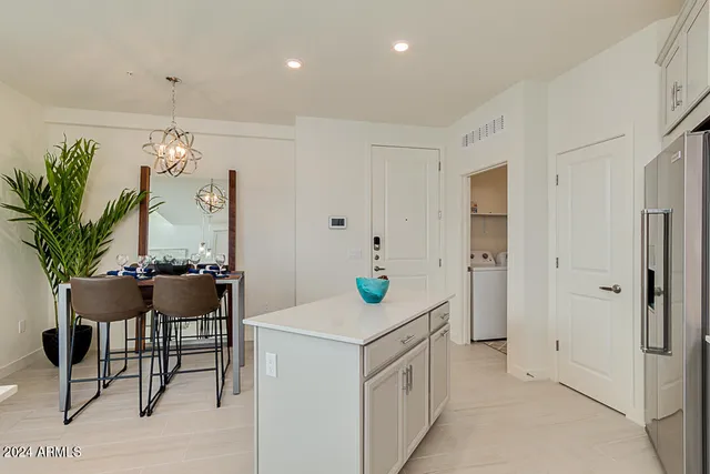 a kitchen that has a table and chairs in it