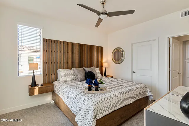 a bed sitting in a bedroom next to a window