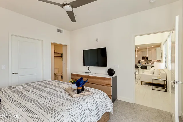 a bedroom with a bed and flat screen tv
