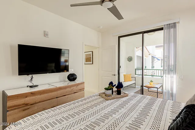 a bedroom with a bed and a flat screen tv