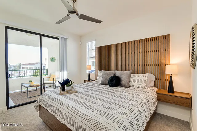 a bedroom with a large bed and a large window