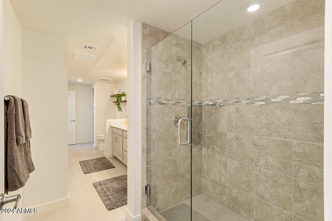 2511 West Queen Creek Road, Unit 416 Chandler, AZ 85248 - Photo 18 of 30 a bathroom with a shower and a toilet