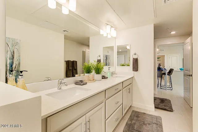 a bathroom with a double vanity sink mirror and double