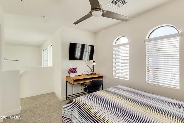 a bedroom with furniture and a window