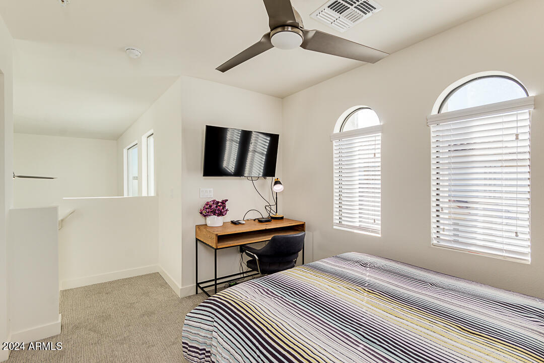 2511 West Queen Creek Road, Unit 416 Chandler, AZ 85248 - Photo 23 of 30 a bedroom with furniture and a window
