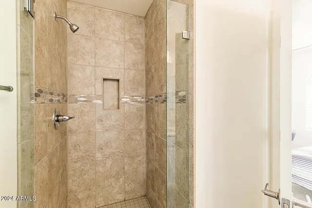 a bathroom with a glass shower door