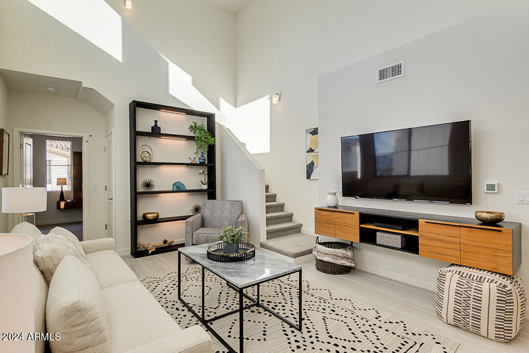 2511 West Queen Creek Road, Unit 416 Chandler, AZ 85248 - Photo 3 of 30 a living room with furniture and a flat screen tv