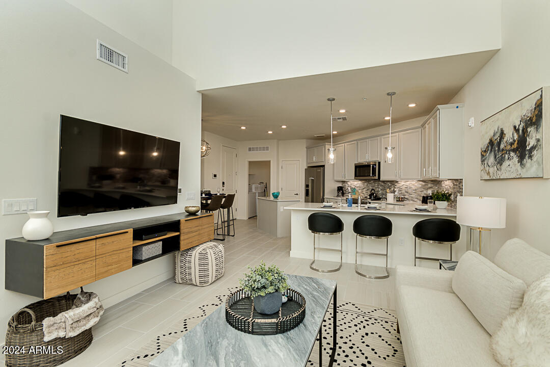 2511 West Queen Creek Road, Unit 416 Chandler, AZ 85248 - Photo 4 of 30 a living room with furniture and a flat screen tv