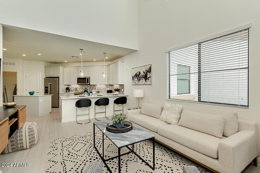 2511 West Queen Creek Road, Unit 416 Chandler, AZ 85248 - Photo 6 of 30 a living room with furniture and kitchen view with a window