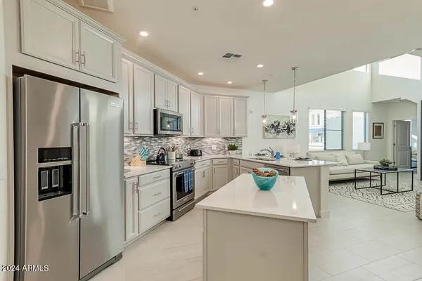 a kitchen with a sink stainless steel appliances and white cabinets